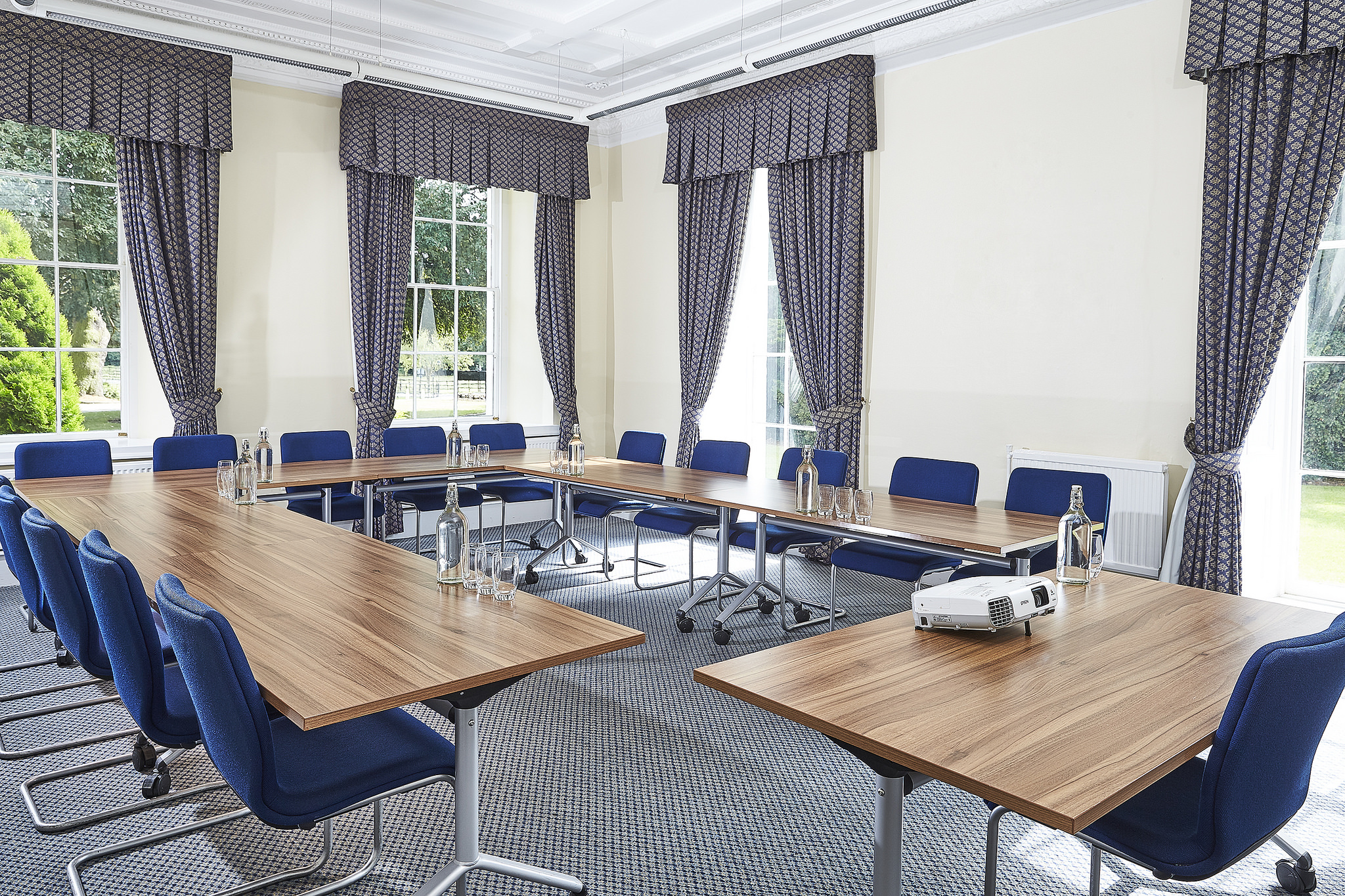 Visitors' Centre meeting room with blue chairs, ideal for conferences and presentations.