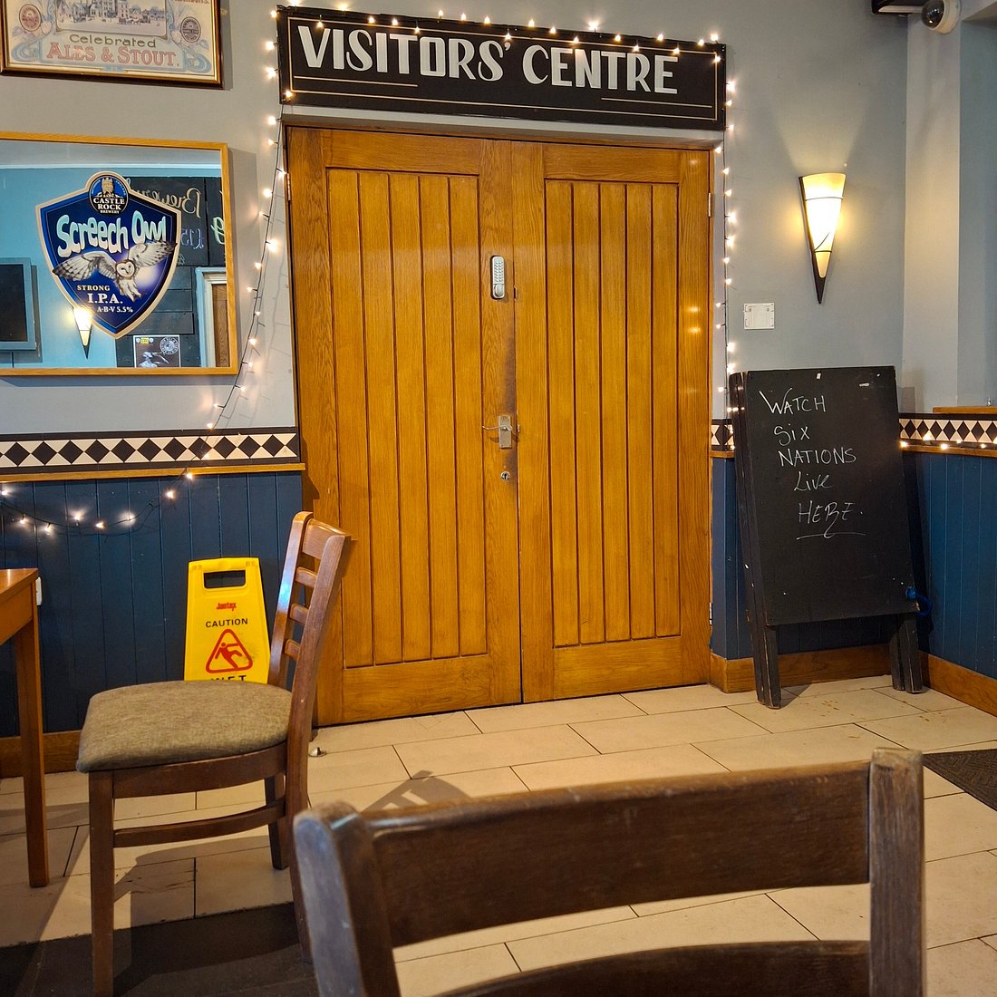 Cozy Visitors' Centre entrance with wooden doors, ideal for events and gatherings.