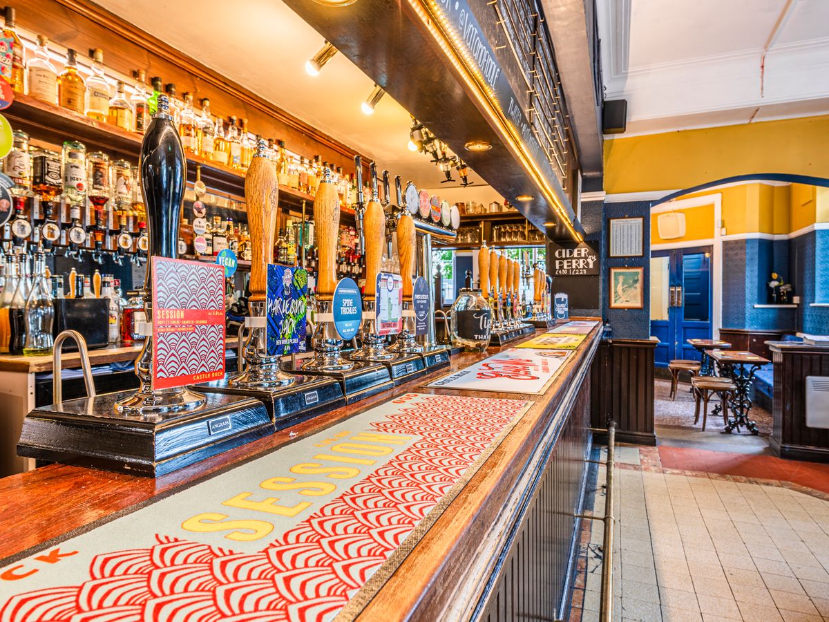 Visitors' Centre at The Vat & Fiddle bar with vibrant taps, perfect for networking events.