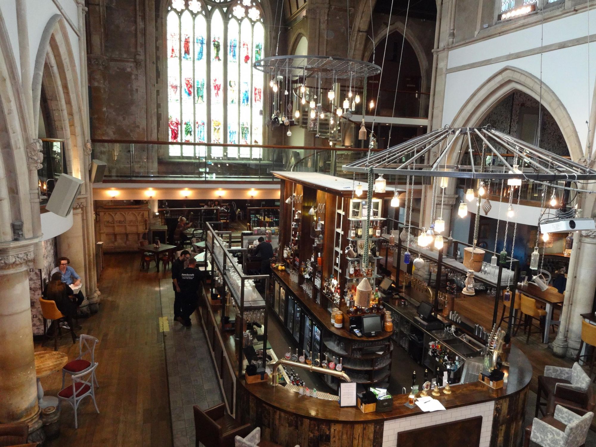 Mezzanine at Pitcher & Piano: historic venue with stained glass, perfect for events and receptions.