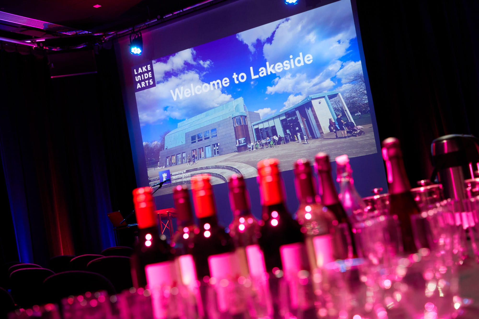 Djanogly Theatre event space with wine setup, ideal for networking and presentations.