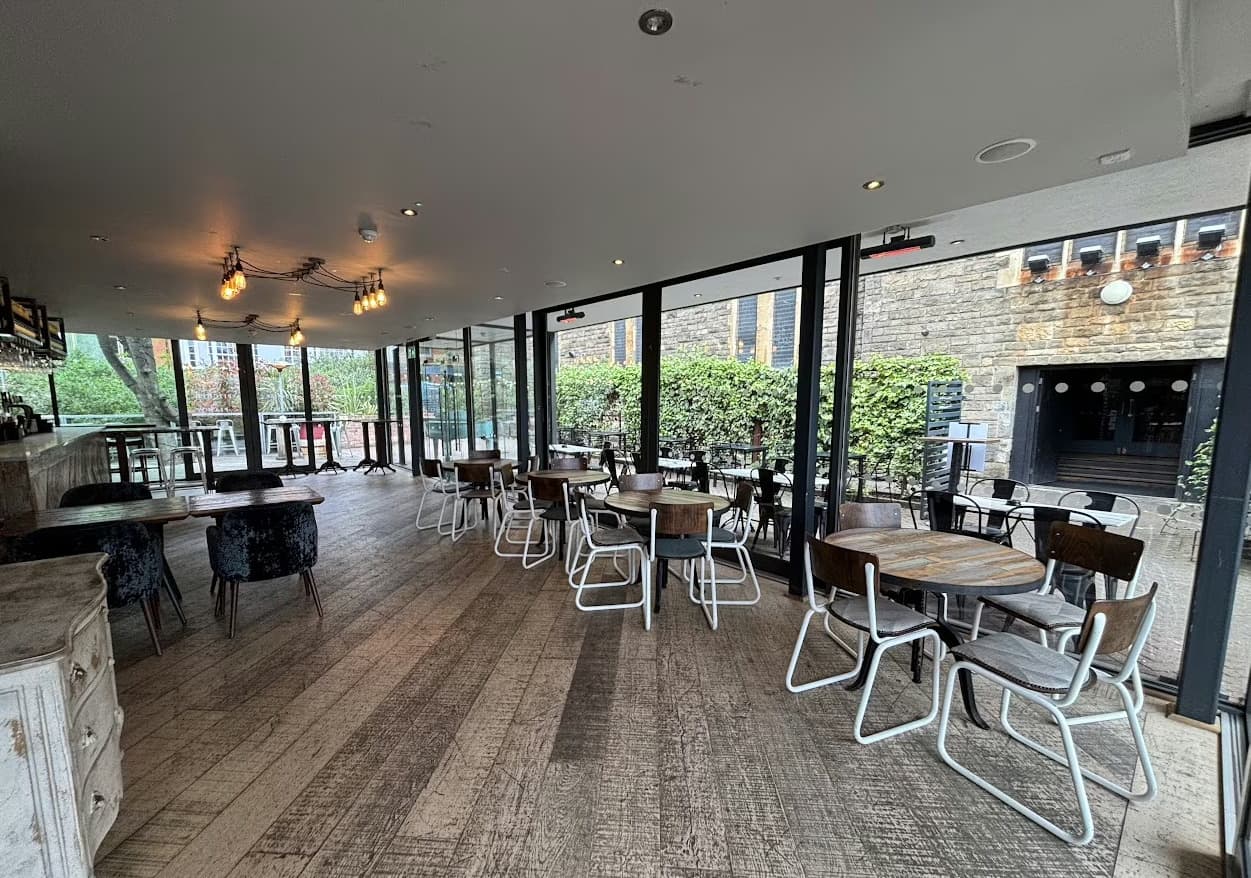 Modern mezzanine event space with large windows for networking and meetings.