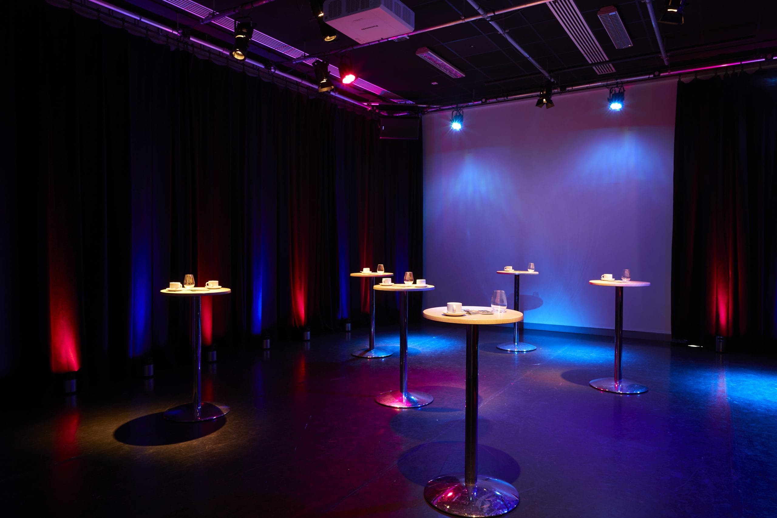 Performing Arts Studio at Lakeside Arts, Nottingham: sleek networking event space with high-top tables.