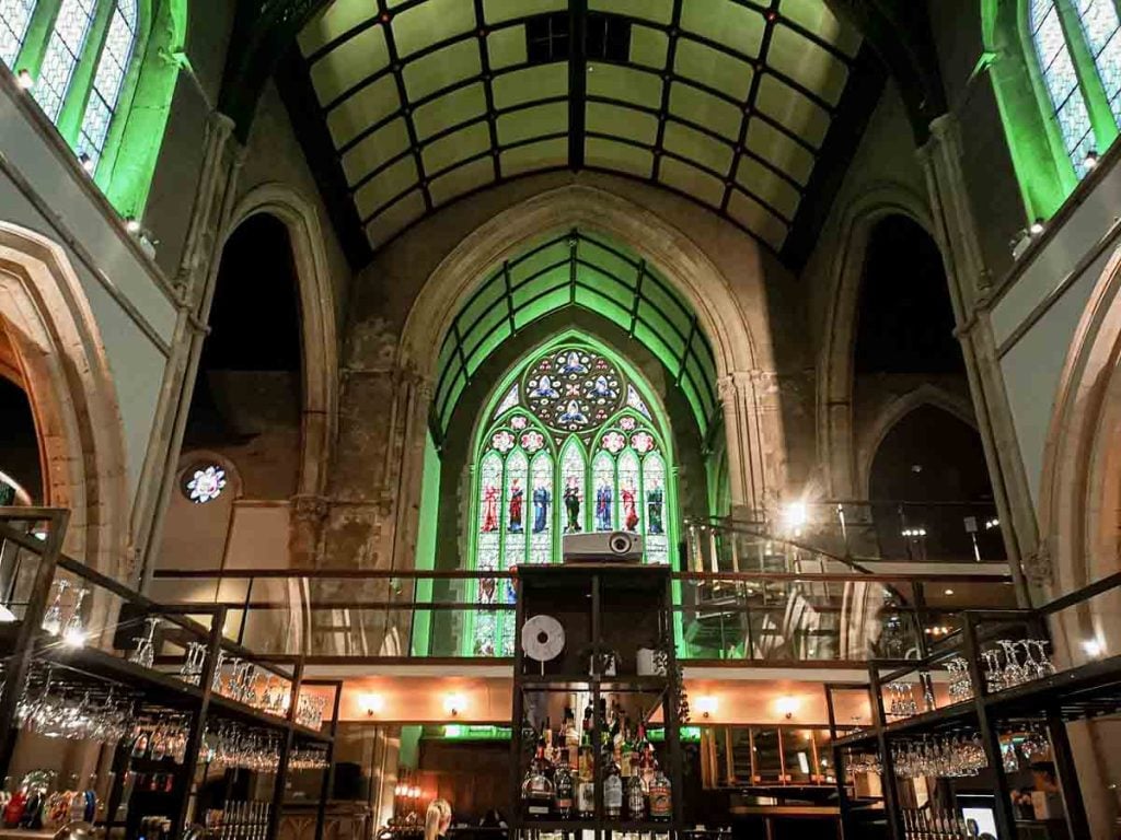 Altar at Pitcher & Piano: stunning converted church venue with stained glass for events.
