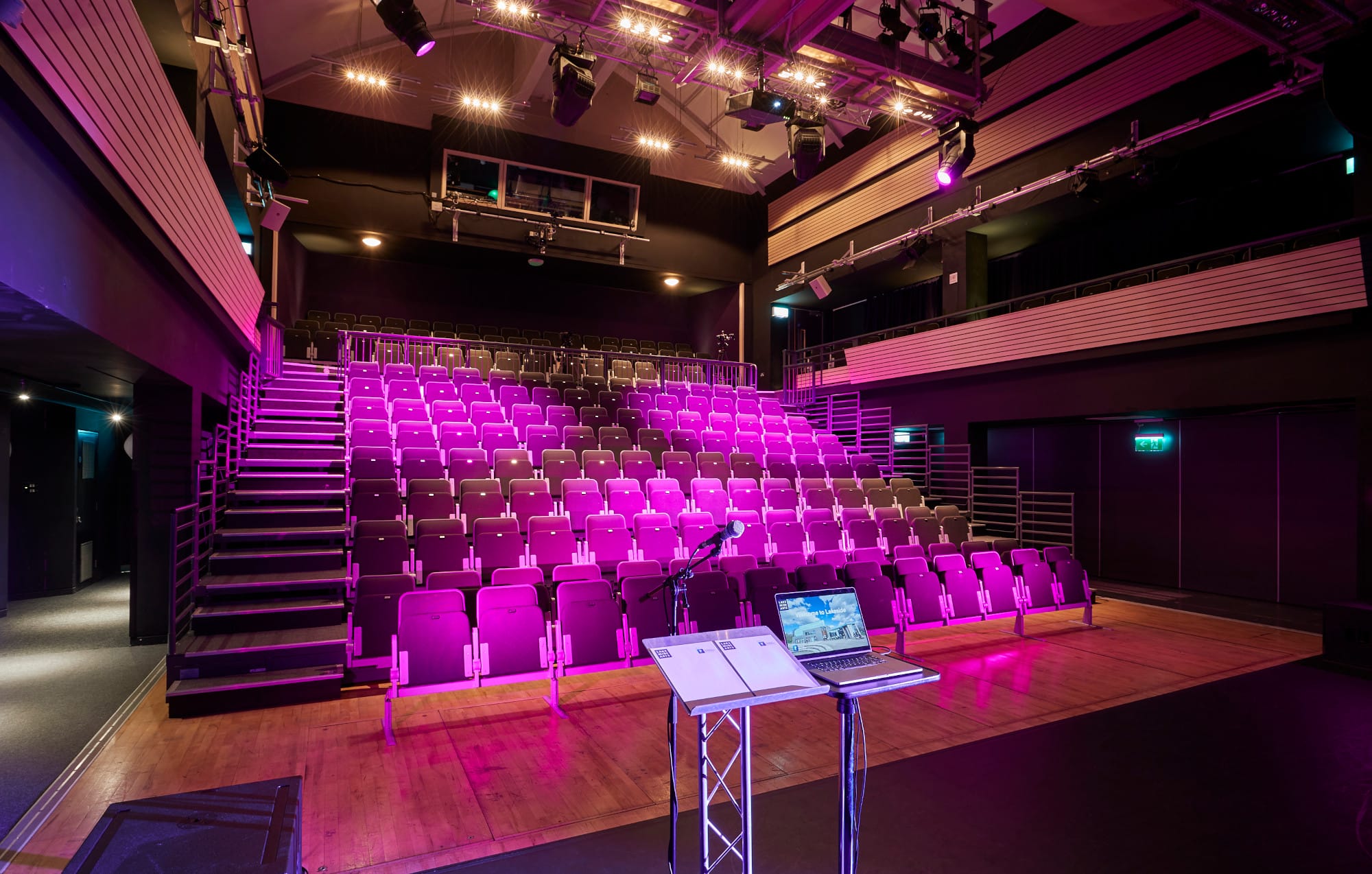 Modern auditorium with tiered seating and vibrant lighting for conferences and workshops.