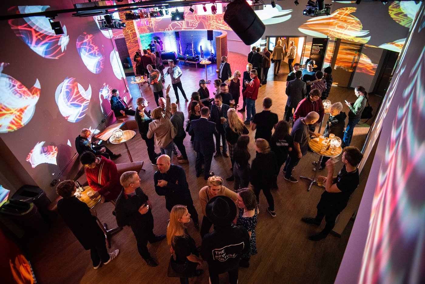 Vibrant networking event at Metronome's Bar & Atrium with dynamic lighting.