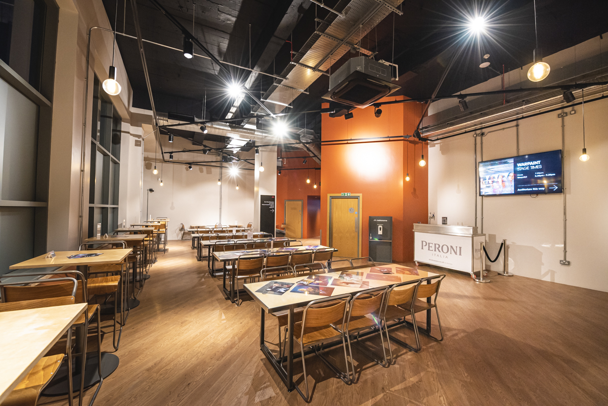 Spacious event space with modern décor, ideal for gatherings and meetings.