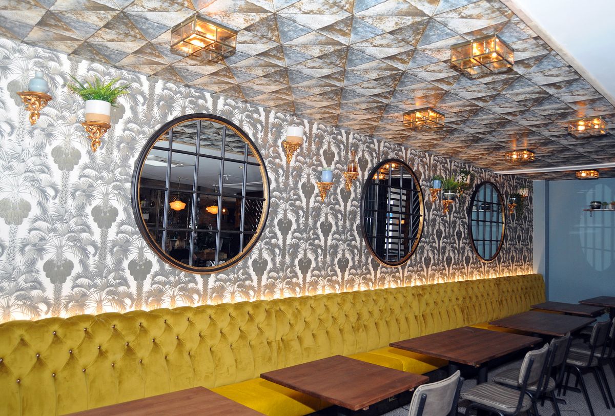 Stylish venue The Snug in West Bridgford with cozy yellow banquette for meetings and events.