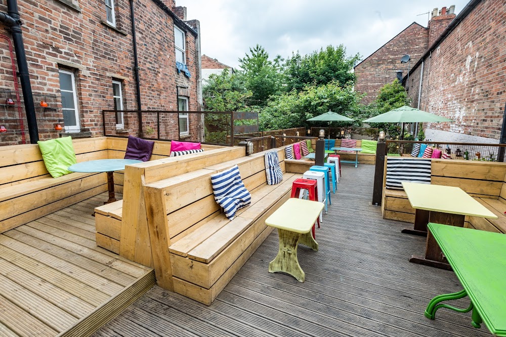 Hidden Rooftop Terrace with colorful cushions, perfect for casual gatherings and networking.