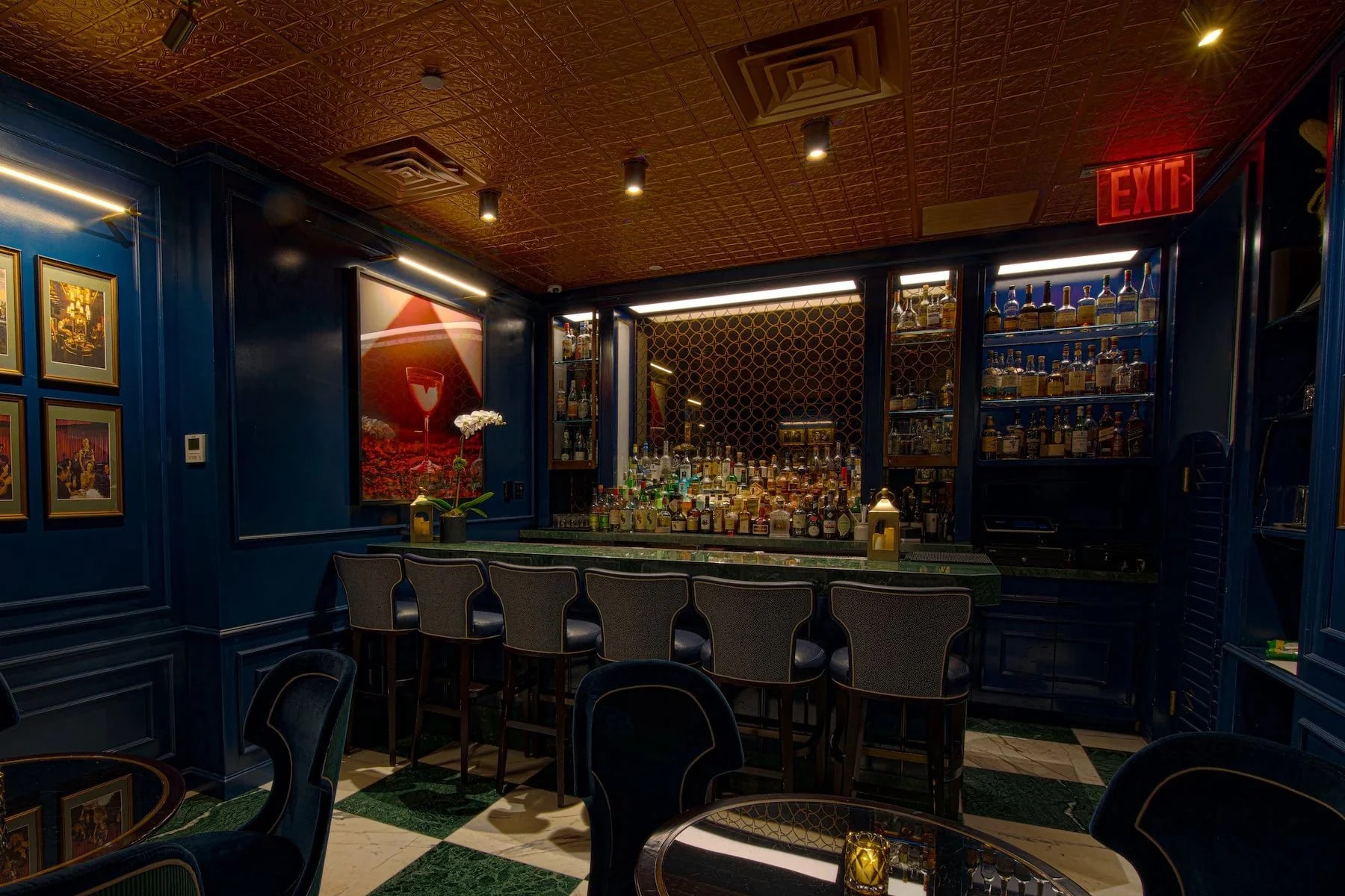 The Crown Post Room bar at The Bell Inn, featuring rich blue walls for stylish gatherings.