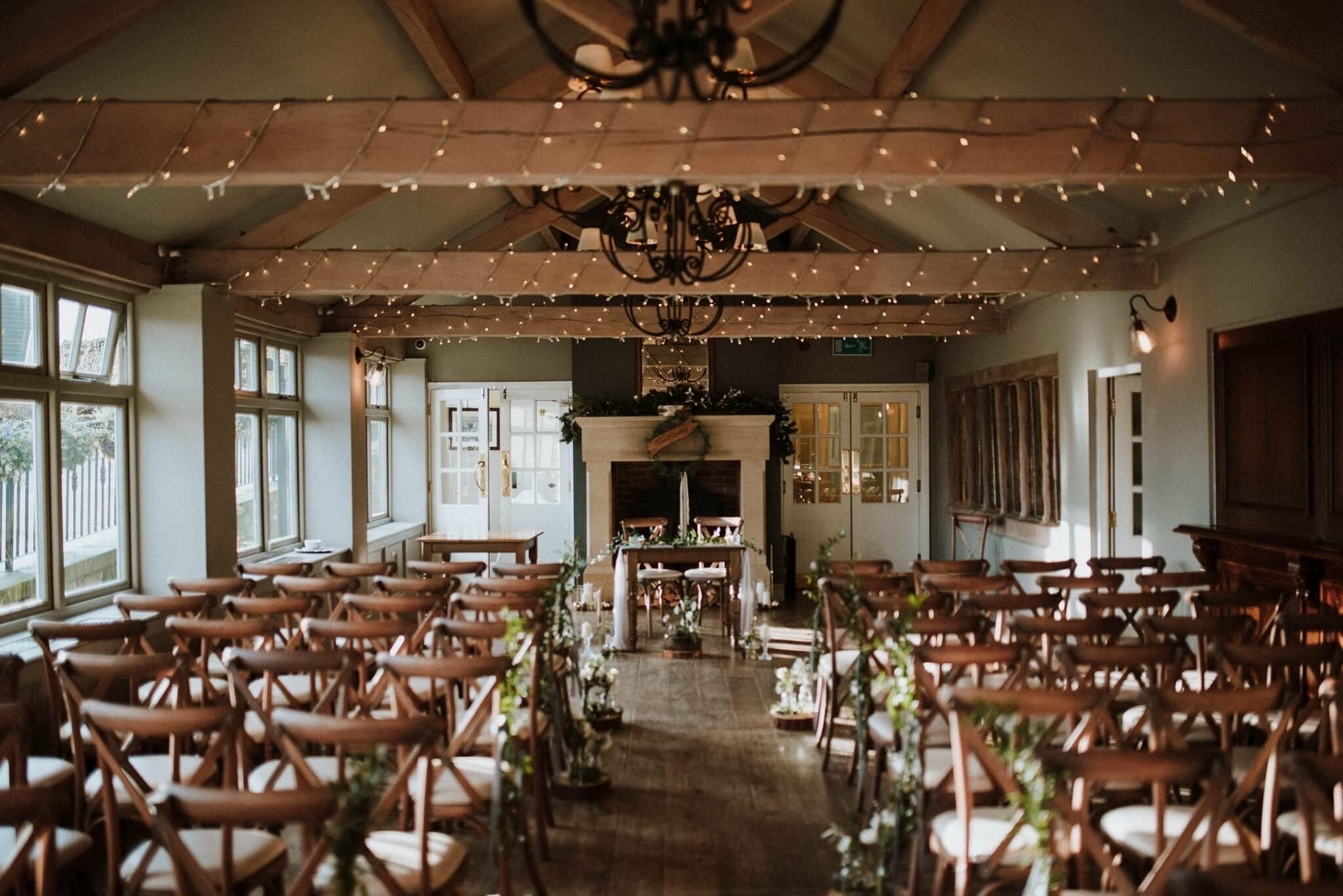 Elegant event space with wooden chairs ideal for intimate weddings and gatherings.