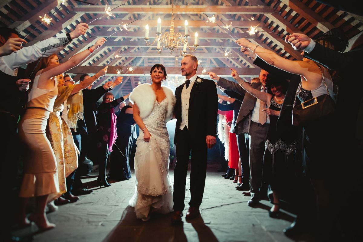 Wedding reception at The Crown Post Room, beautifully decorated barn with warm lighting.
