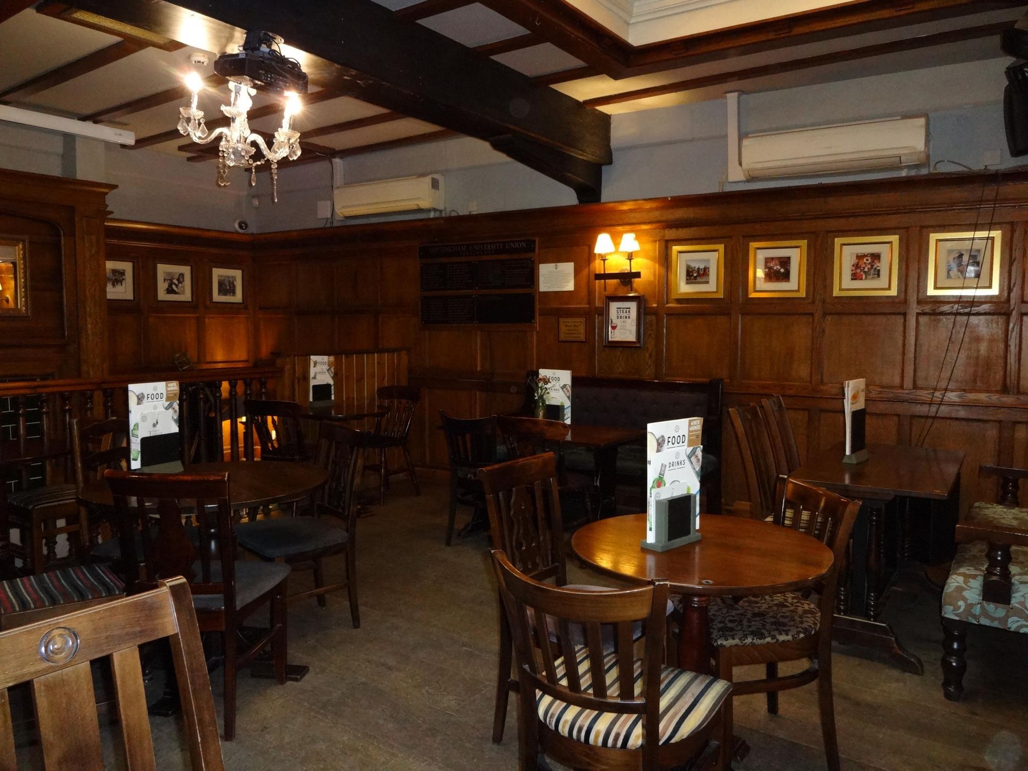 Cozy venue with warm wood paneling for intimate meetings and small events at The Belfry.