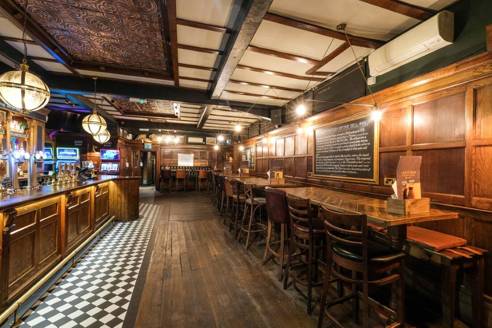 Rustic event space at The Belfry, featuring dark wood paneling for networking and gatherings.