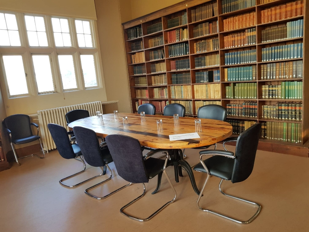 Lord Middleton Suite at Wollaton Hall: elegant meeting room with wooden table for professional events.