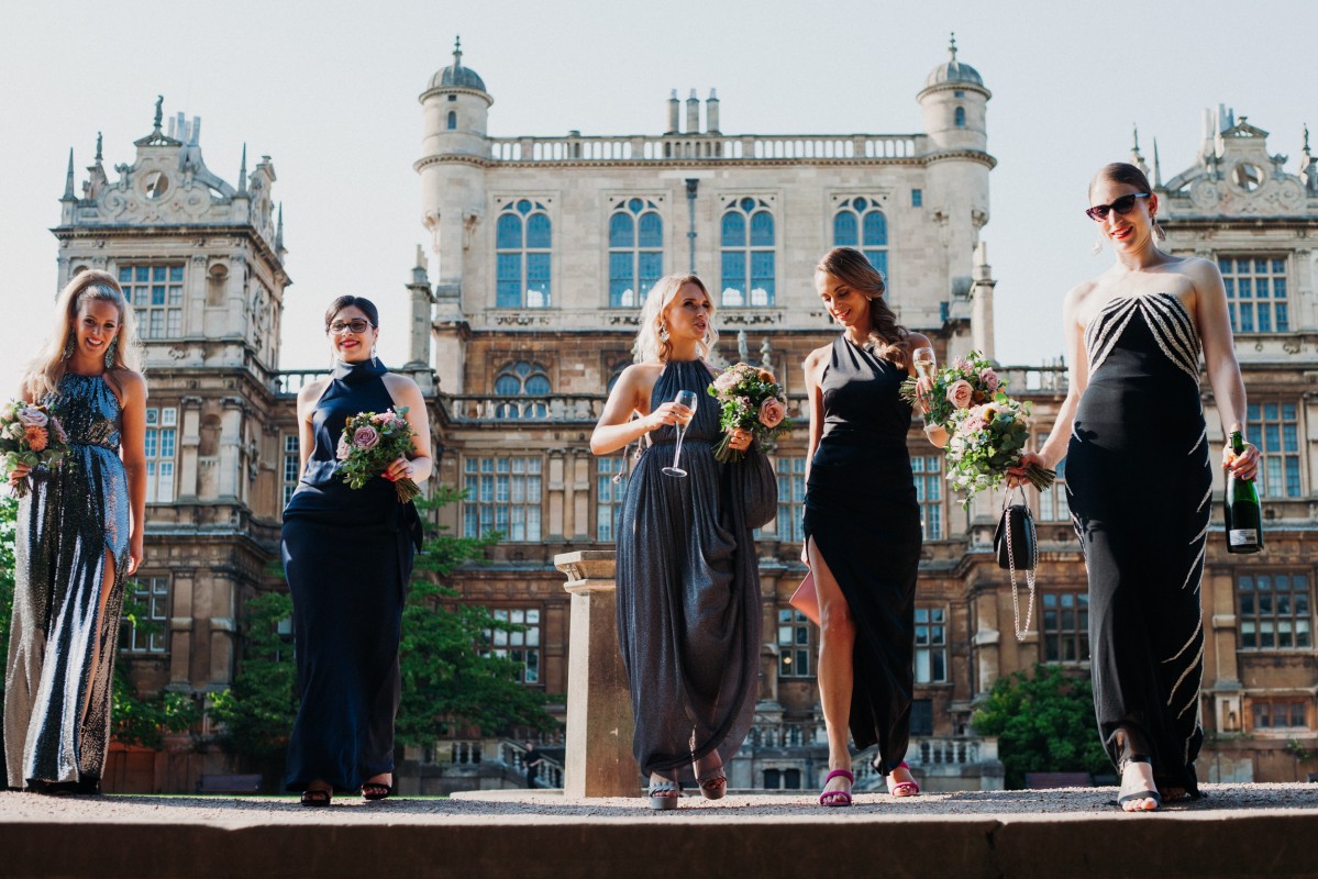 Elegant women in formal attire at Wollaton Hall, perfect for weddings and celebrations.