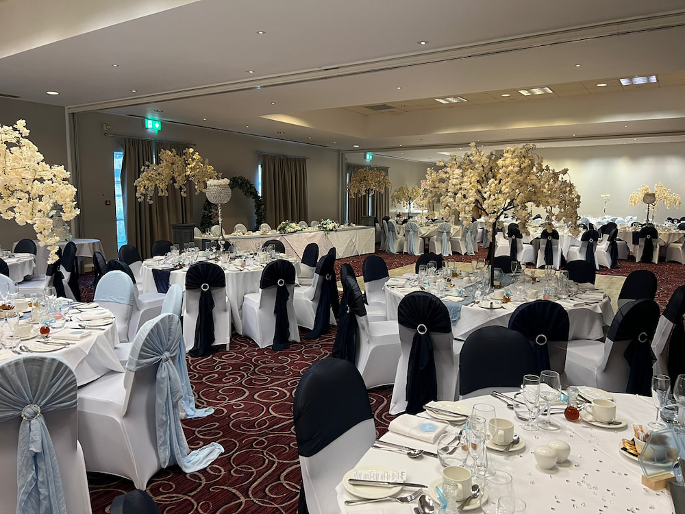 Lawrence Suite wedding reception with grand floral centerpieces and monochrome decor.