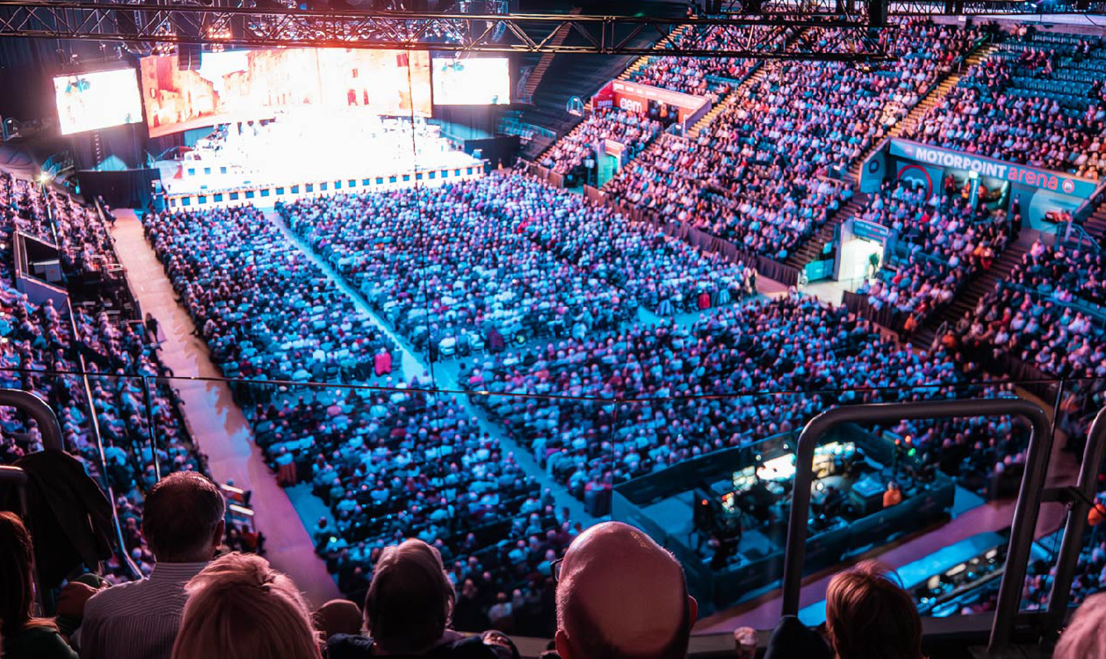 Main Arena at Motorpoint Nottingham with vibrant lighting, showcasing a large engaged audience event.