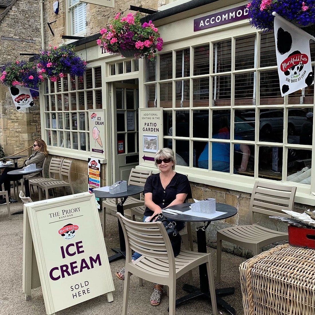 Outdoor café at The Priory Burford, ideal for networking events with comfy seating.
