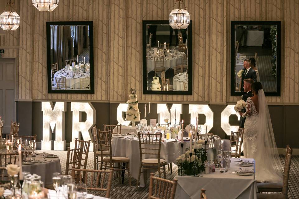 Westonbirt Room wedding reception with elegant tables and romantic decor at Hare & Hounds Hotel.