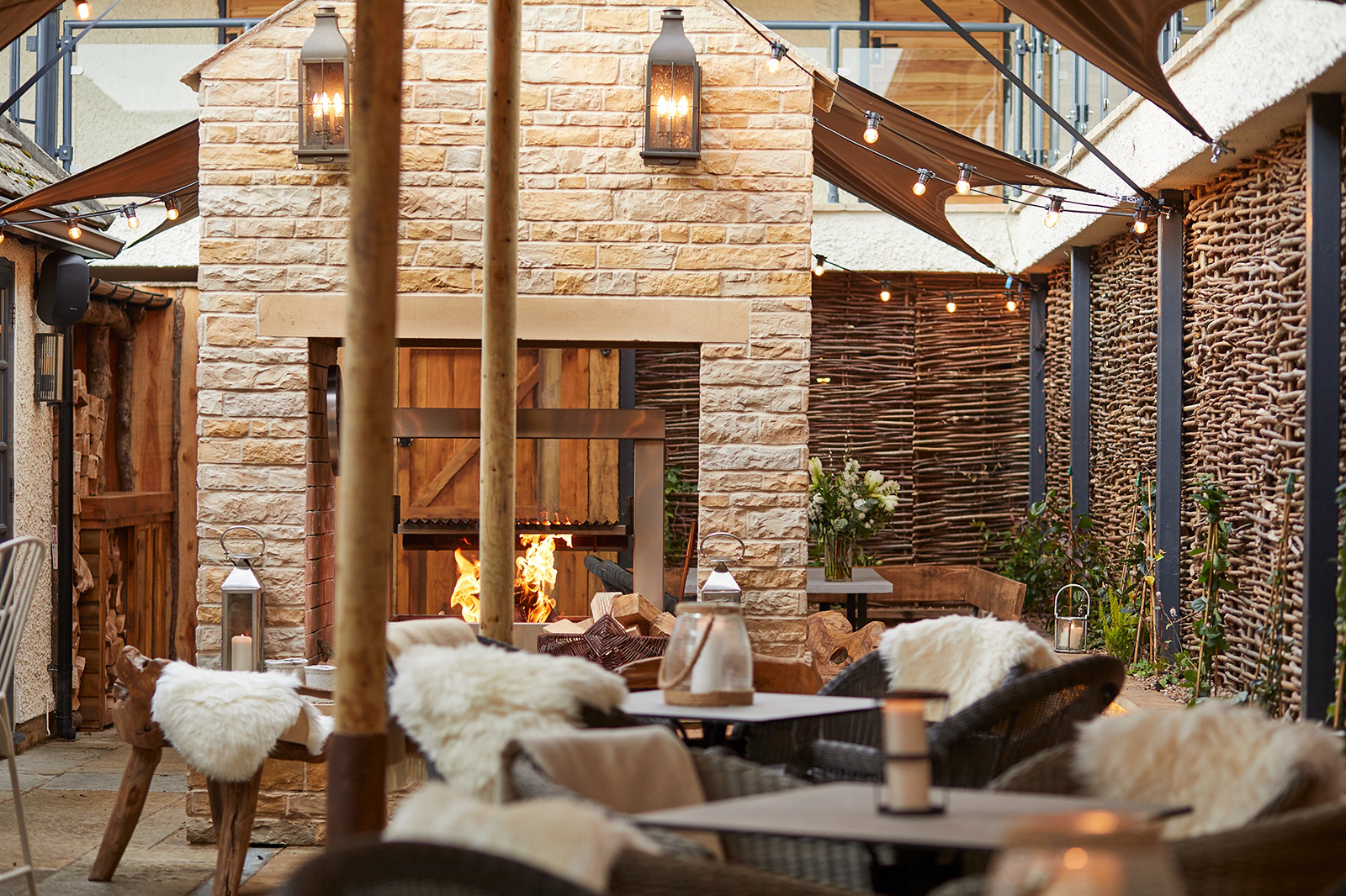 Rustic outdoor event space with stone fireplace at Wild Thyme & Honey Suite, intimate gatherings.