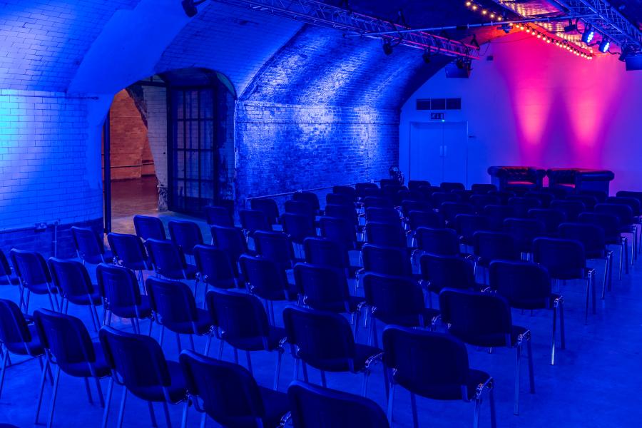 Versatile event space at IKLECTIK with archway ceiling, ideal for corporate workshops.