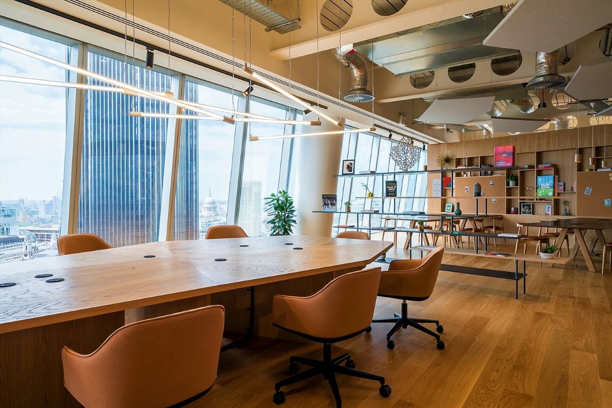 Modern conference room with wooden table, ideal for corporate meetings and brainstorming.