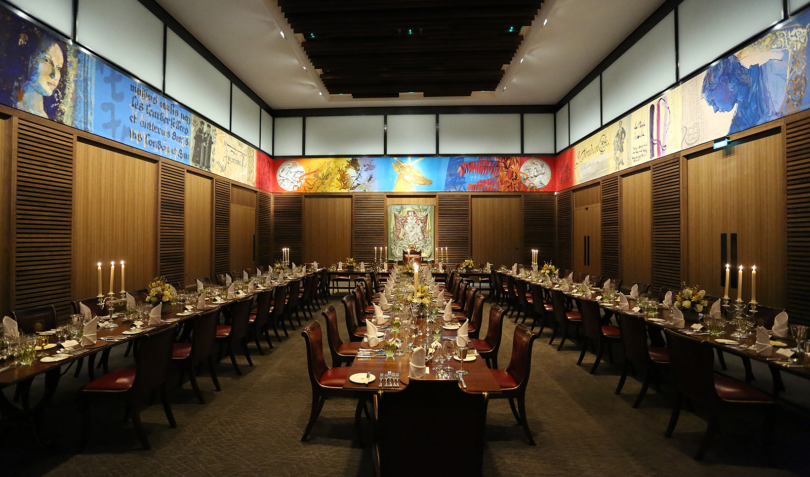 Elegant dining hall setup with fine tableware for corporate events and upscale celebrations.