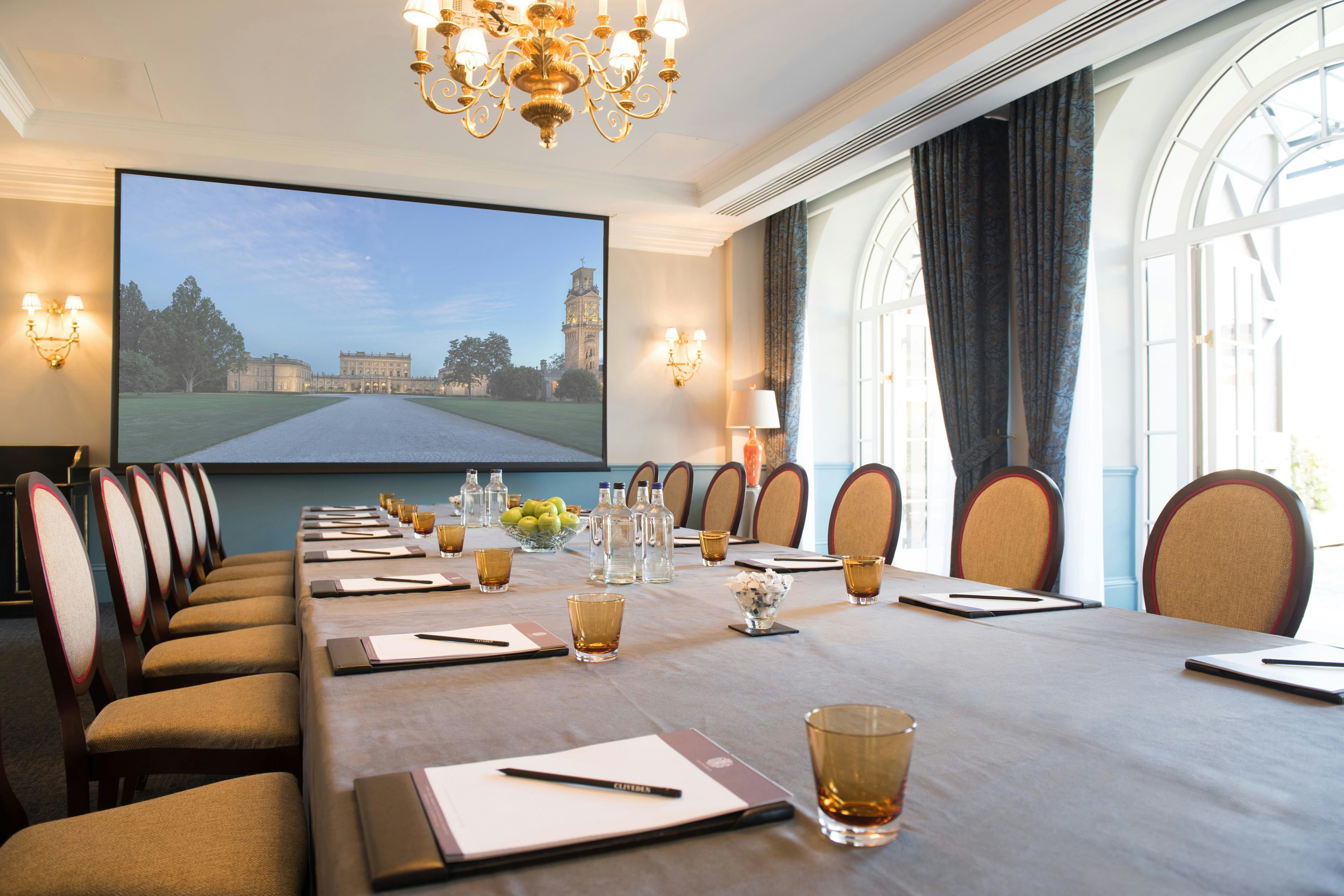 Boardroom setup at The Churchill, Cliveden House with AV screen for executive meetings and conferences.