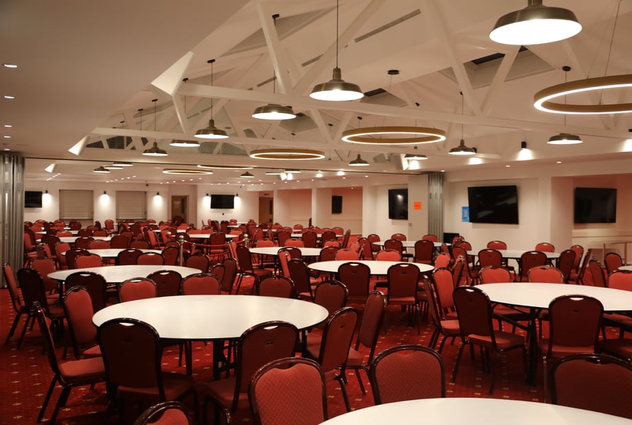 Dining Hall in Navnat Centre: spacious venue with red chairs, ideal for meetings and banquets.