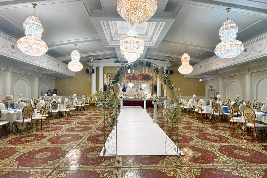 Elegant banquet hall with chandeliers, ideal for weddings and formal events.