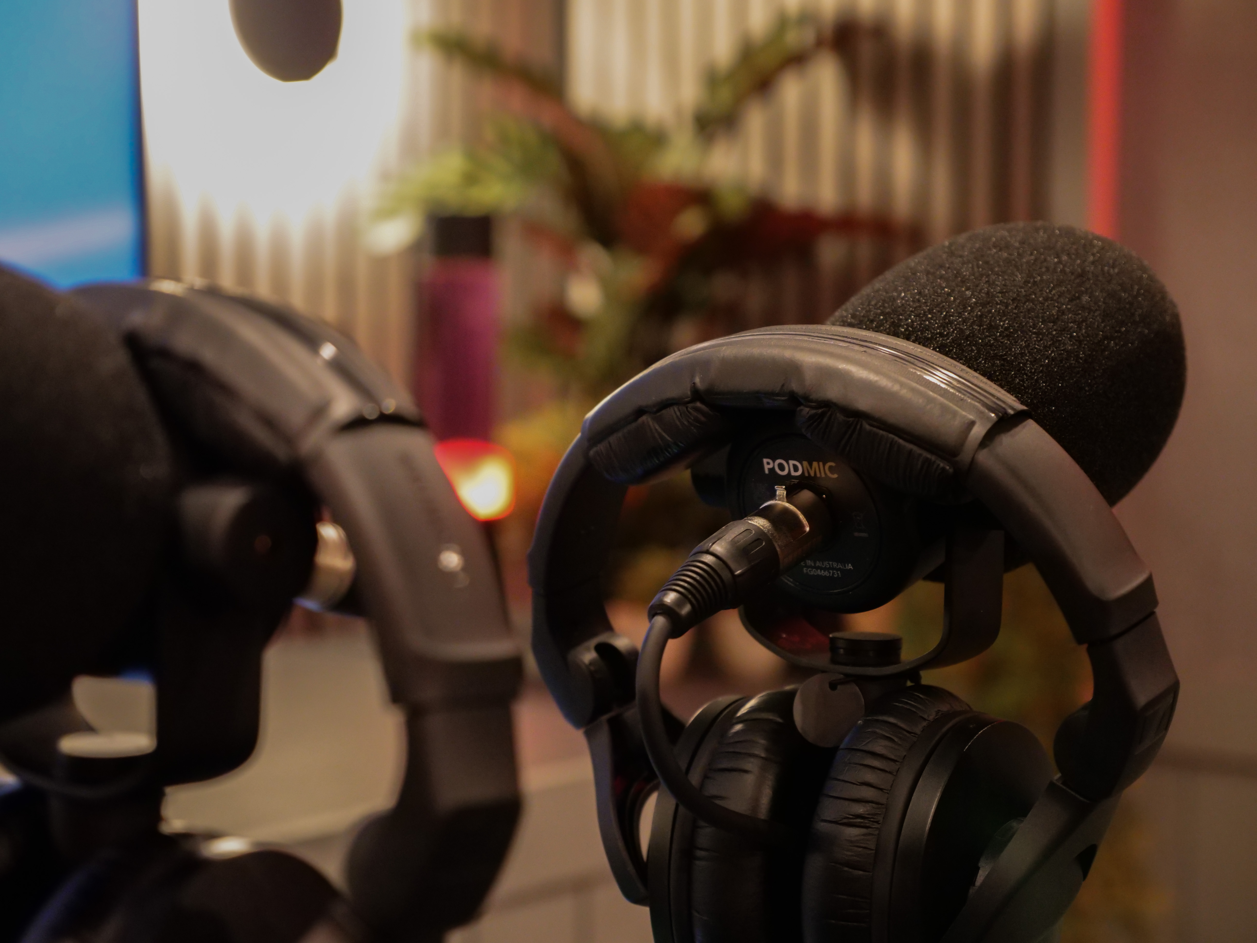 Podcast room with headphones and microphones for impactful events and presentations.