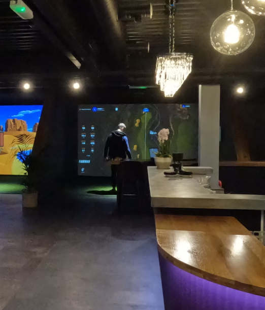 Modern event space at Inner Drive Golf with advanced projection for corporate gatherings.