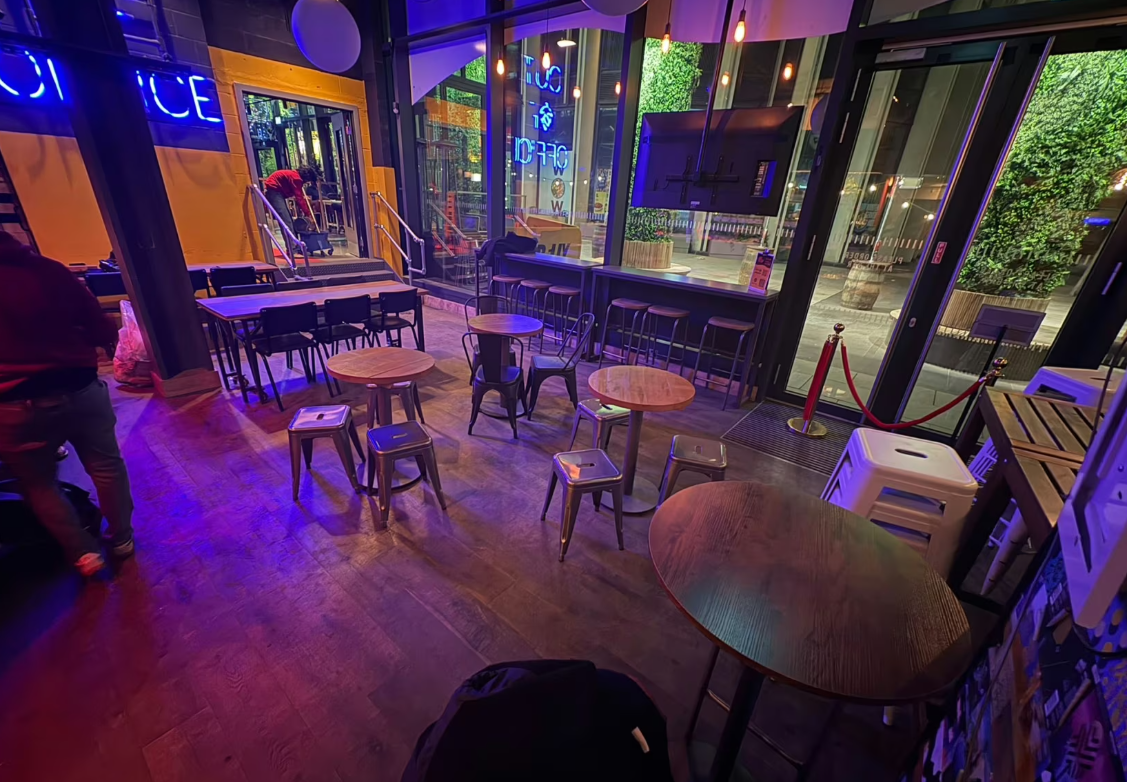 Industrial-chic breakout area at Big Belly Bar, ideal for networking and corporate happy hours.