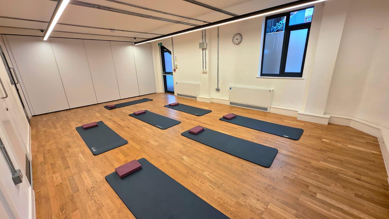 Versatile Chelsea Theatre Studio 3, bright yoga space with mats for mindfulness events.