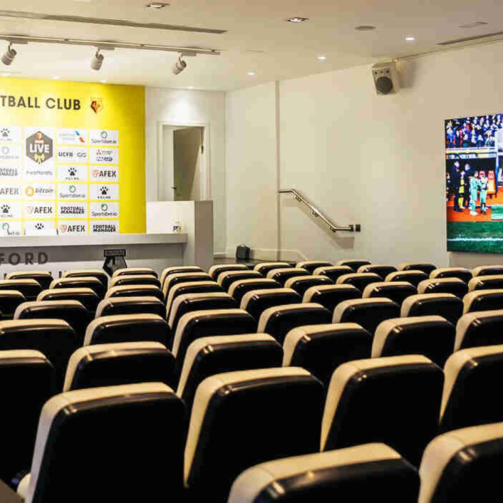 Press conference room at Watford F.C. with tiered seating for media events
