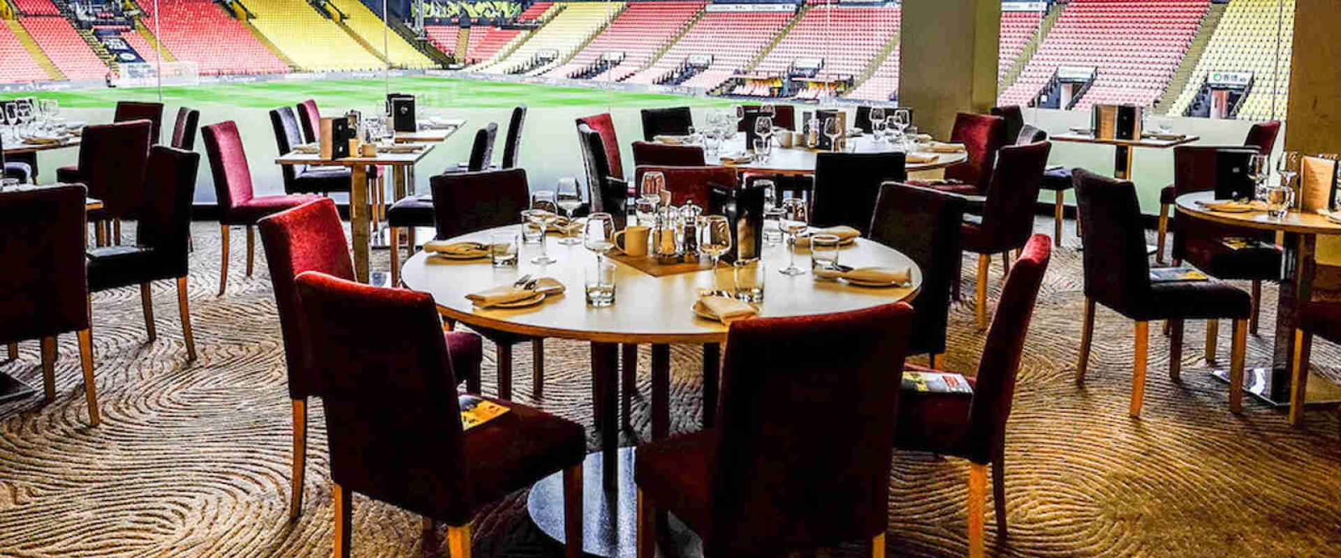 Stylish dining area at Watford F.C. for corporate events overlooking sports field.