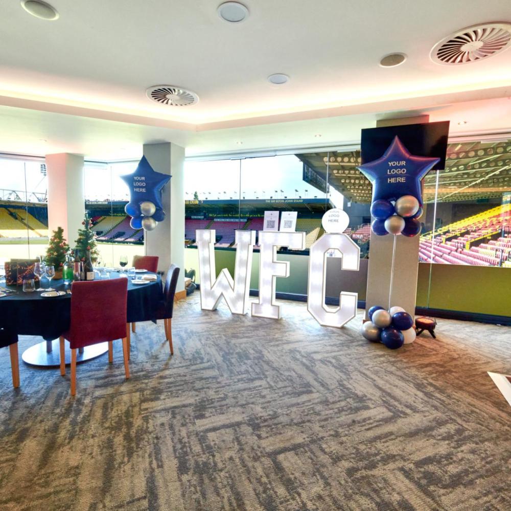 Vibrant event space at Watford F.C. with "WE C" letters for celebrations and gatherings.