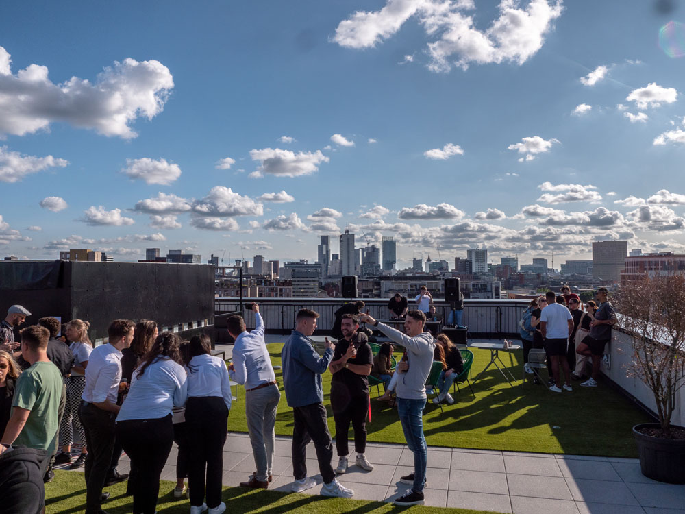 Vibrant rooftop event at Silk Street with city skyline, ideal for networking gatherings.