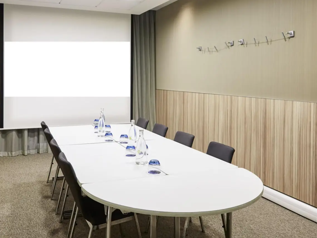 Albert Johnston in a professional meeting space with an oval table for workshops and presentations.