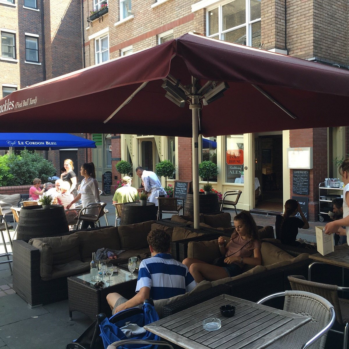 Outdoor venue at The Port House with umbrella seating for casual meetings and events.