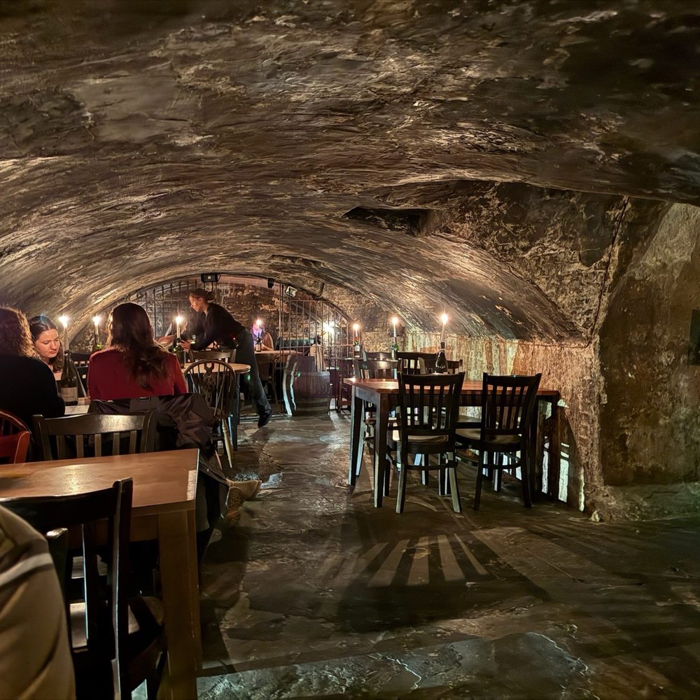 Intimate underground venue with stone arches, perfect for private dinners and corporate events.