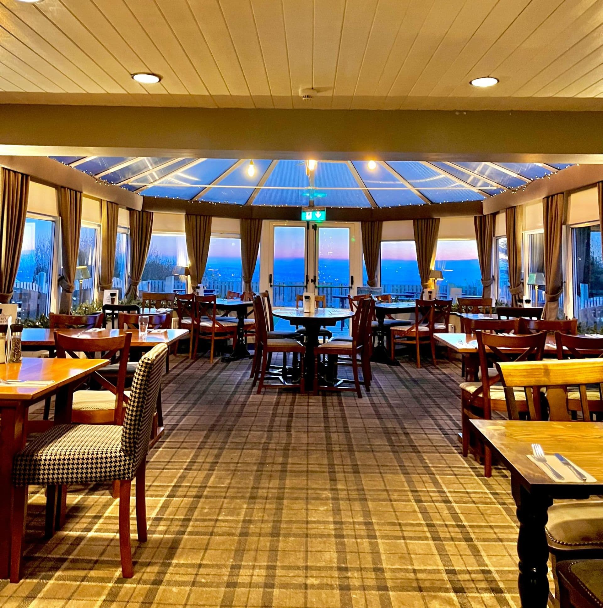 Conservatory event space, plaid carpet, elegant dining, corporate party