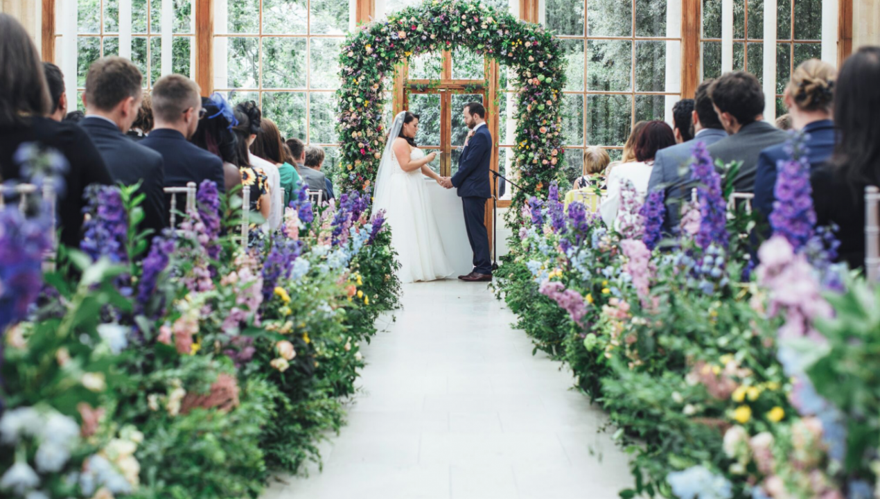 Conservatory wedding, floral arch, romantic event.