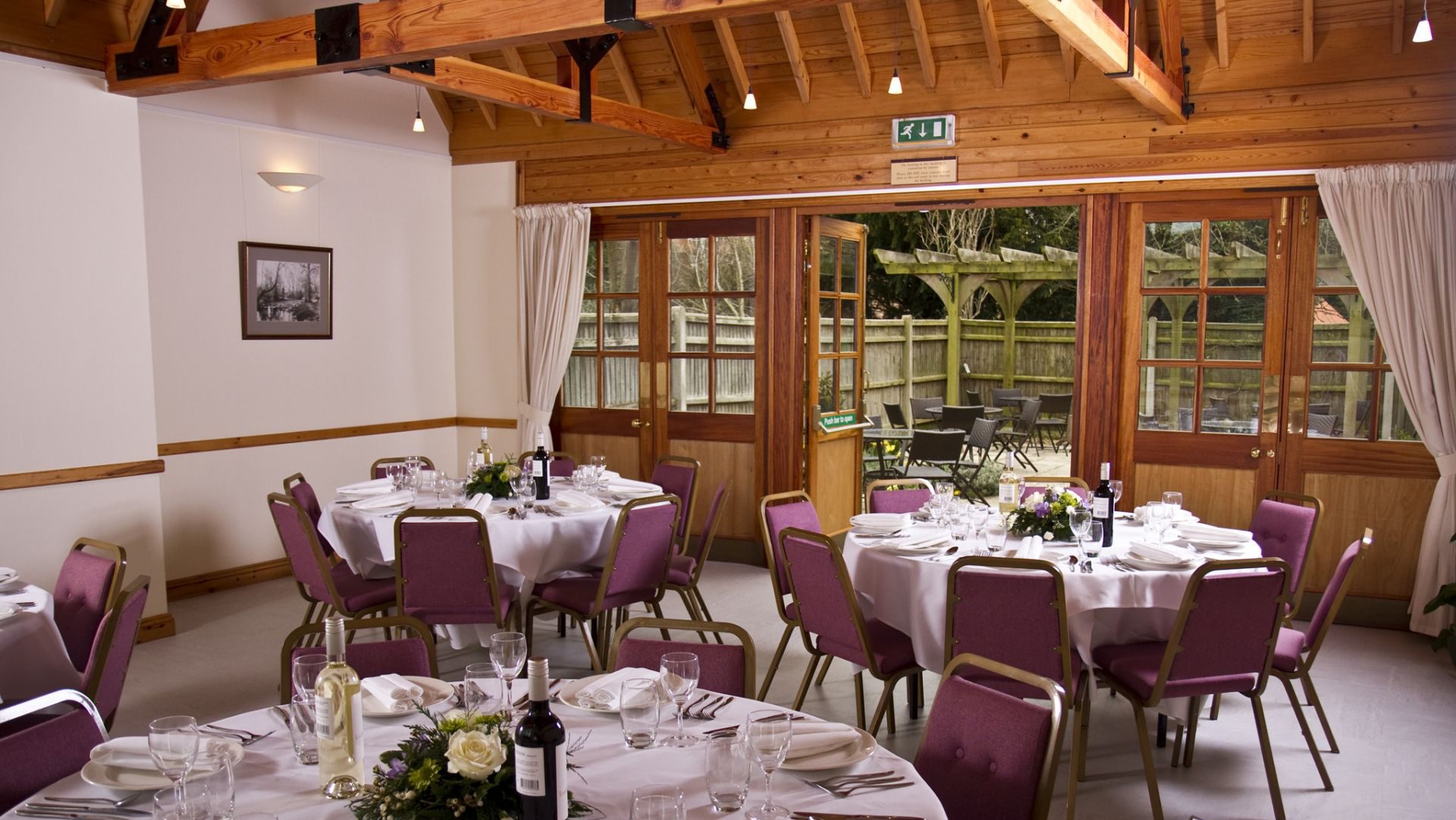 Elegant banquet space with round tables for weddings and corporate events.