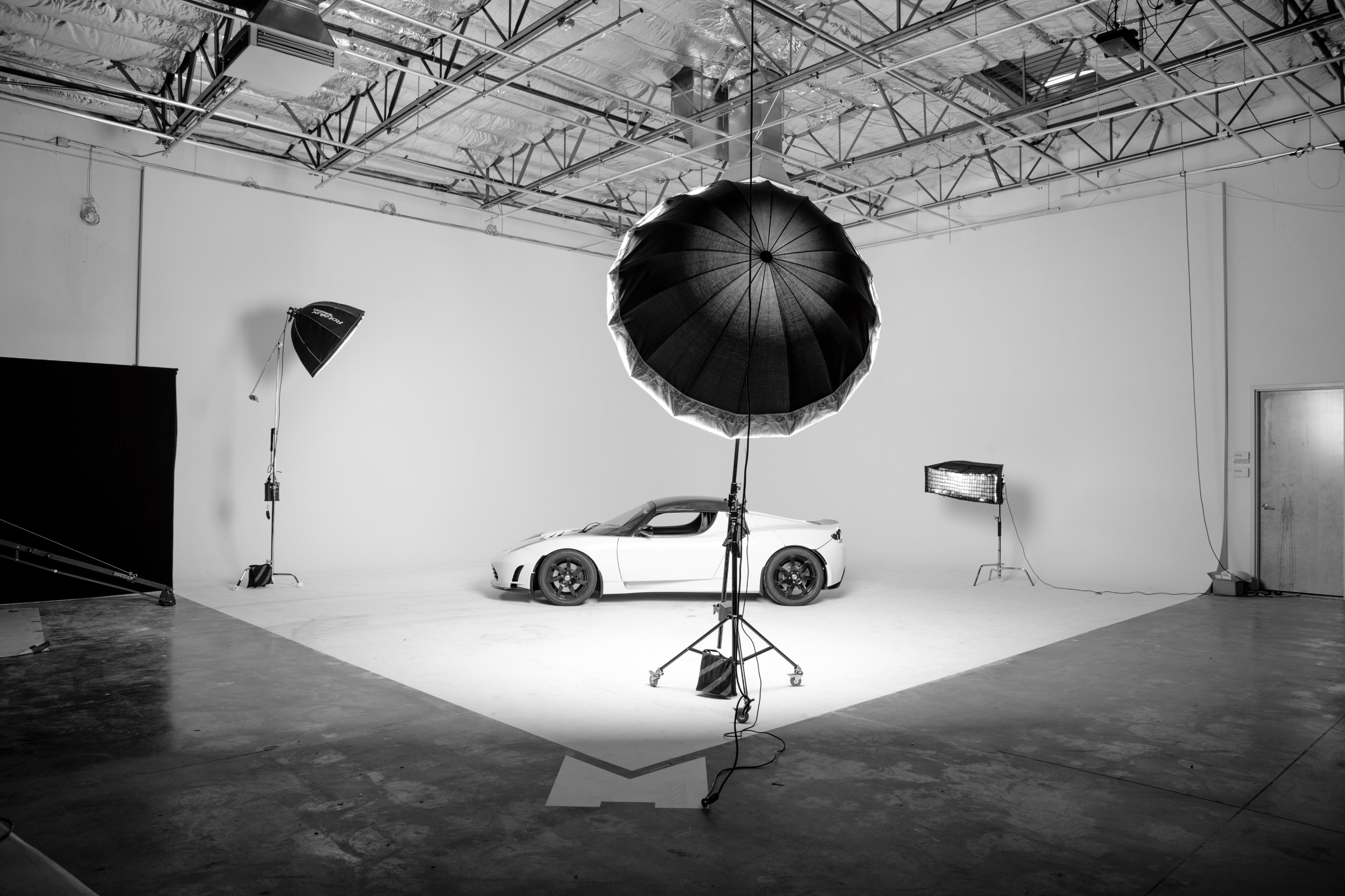 Clean automotive photography studio with professional lighting for product showcases.