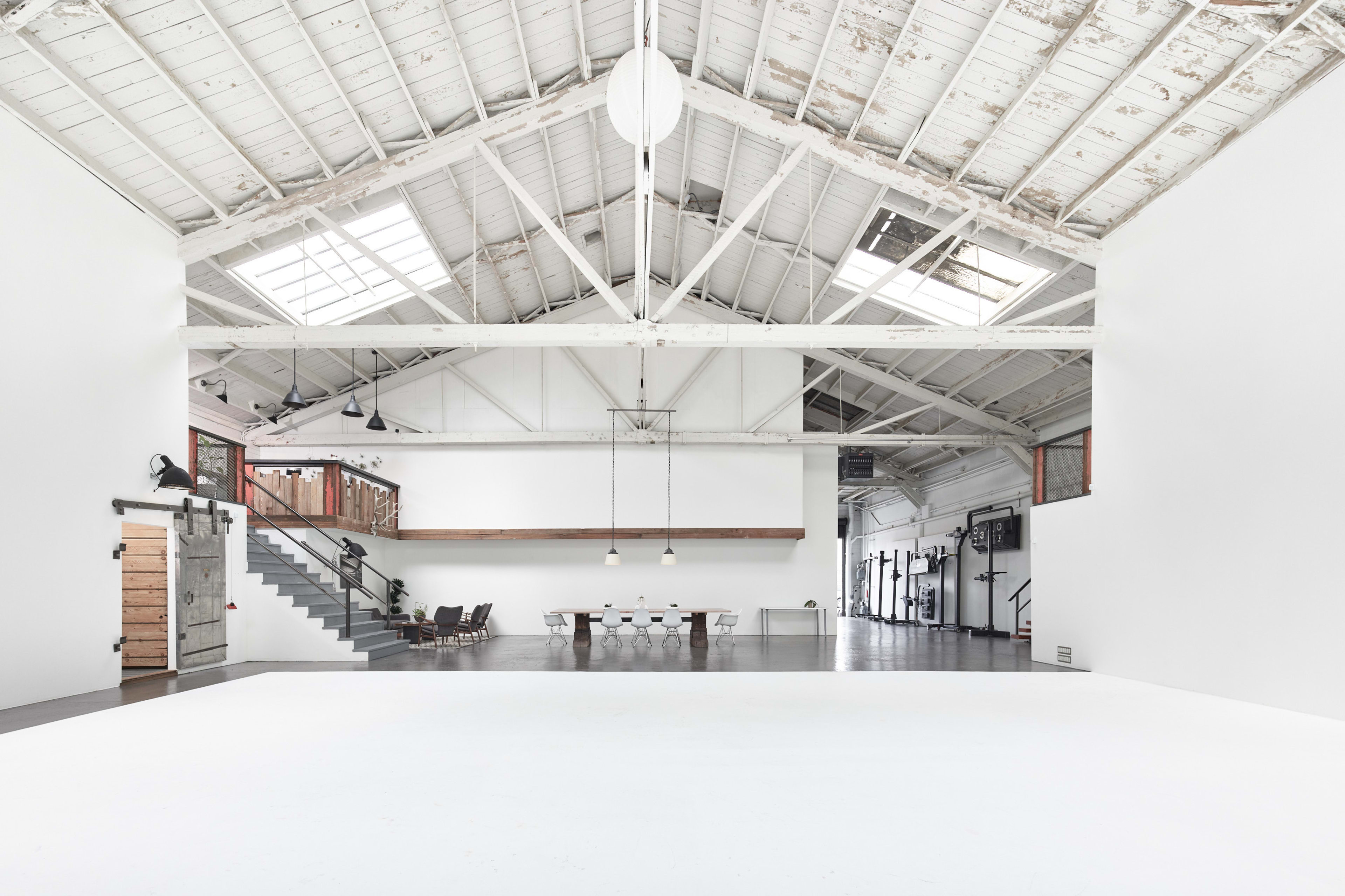 Spacious modern event venue with high ceilings, ideal for workshops and networking.