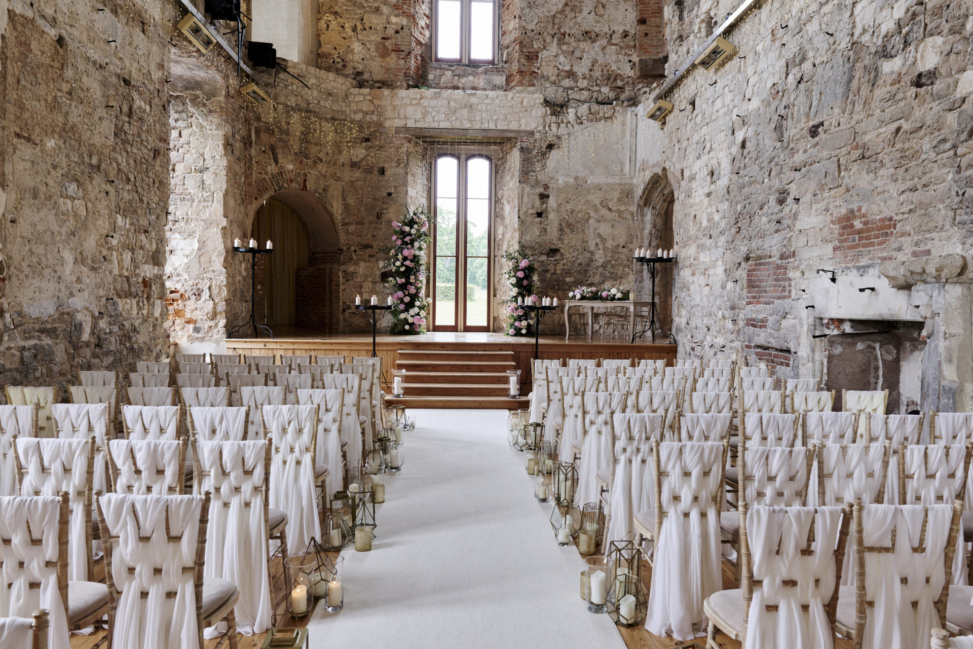 Historic stone venue with elegant ceremony seating for luxury weddings and corporate events.