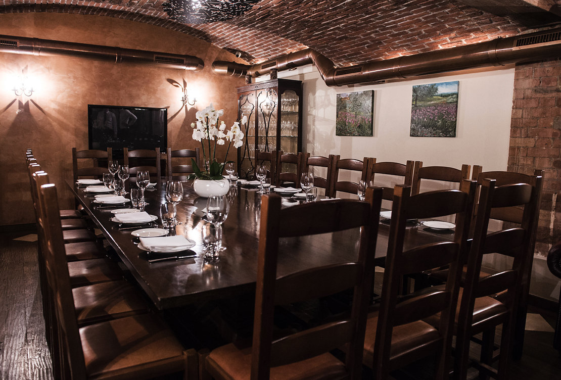 Elegant dining space with rustic brick walls, perfect for private events and meetings.