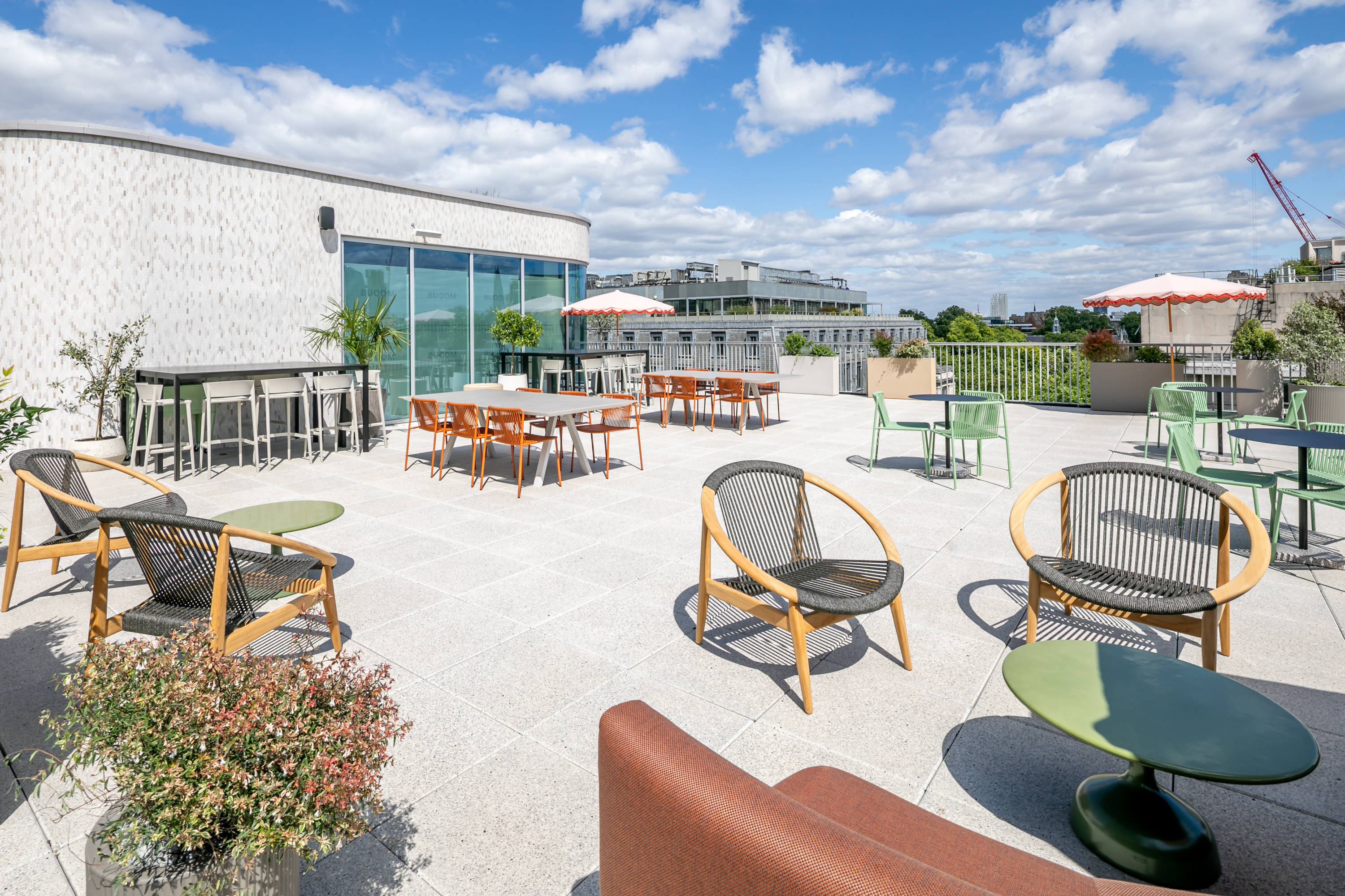 Rooftop networking venue, chic seating, client engagement, team building.
